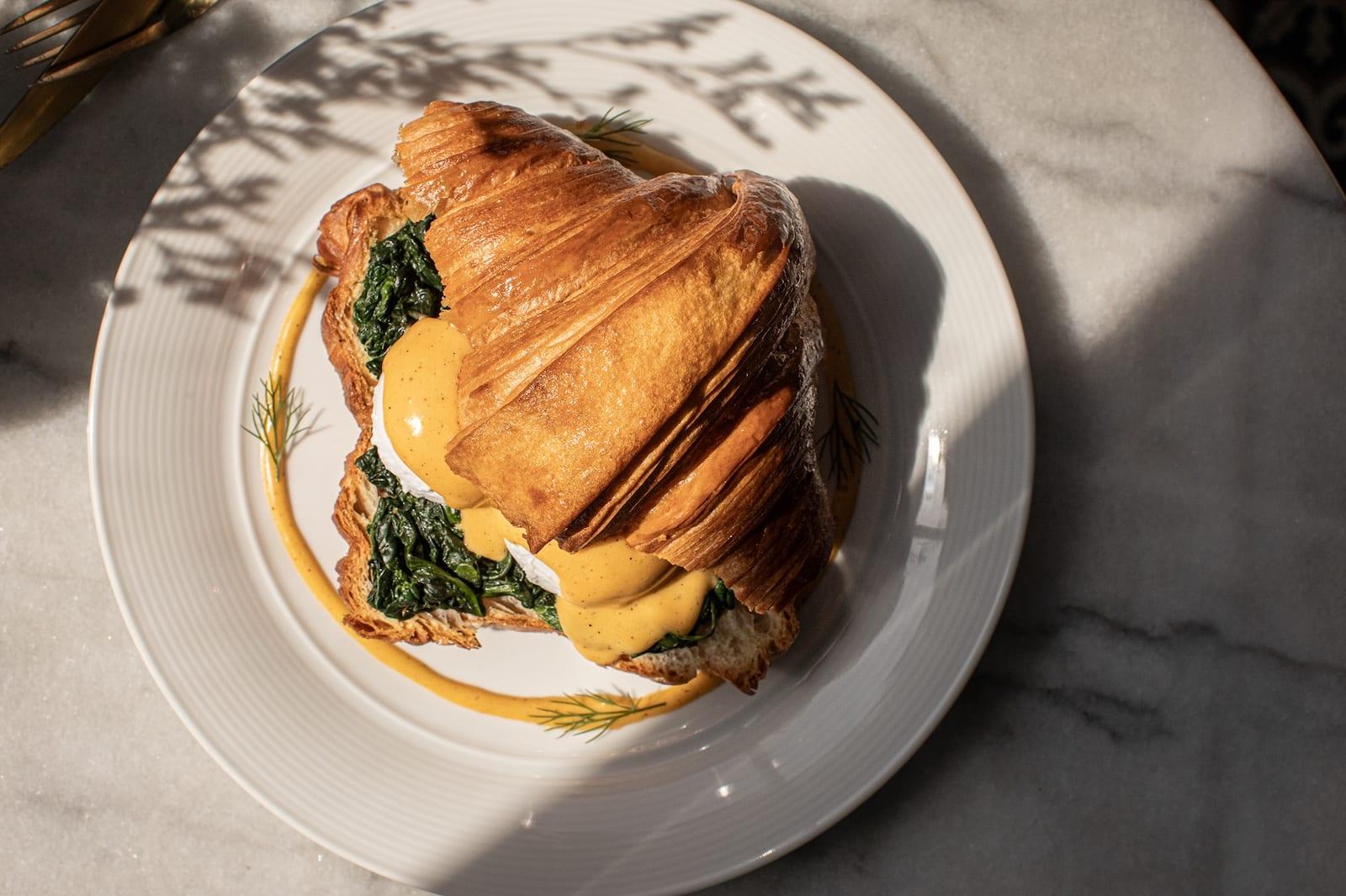 Croissant eggs Benedict in morning light